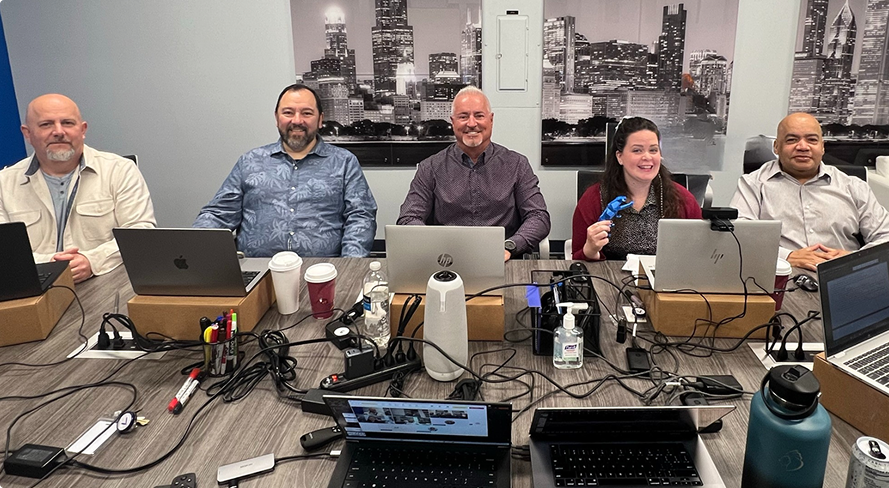 Company members sitting in front of laptops