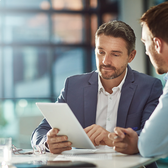 Two men looking at a tablet